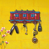 Load image into Gallery viewer, Retro train-shaped wooden key holder with multicolor design on a yellow wall, featuring seven hooks for keys.